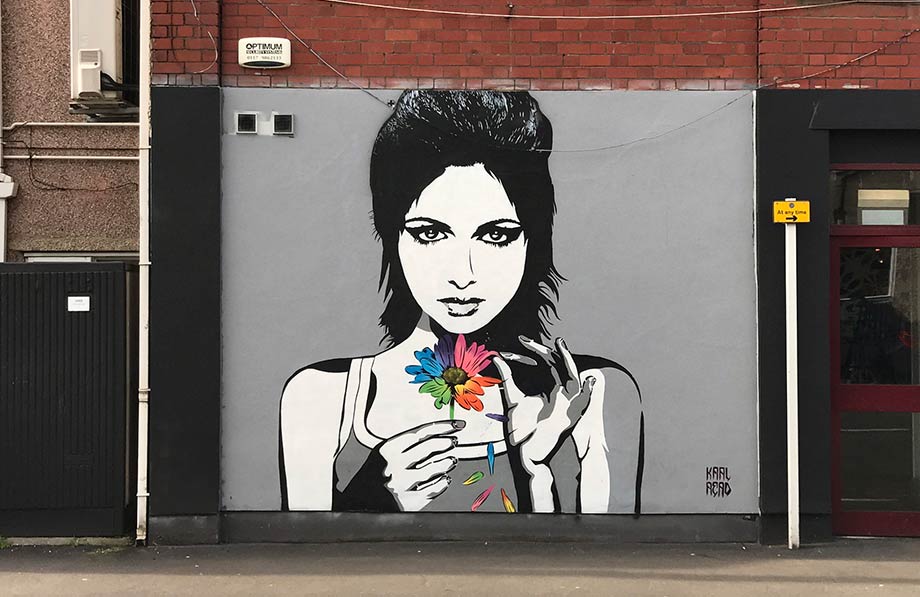 Graffiti on wall of person with a flower
