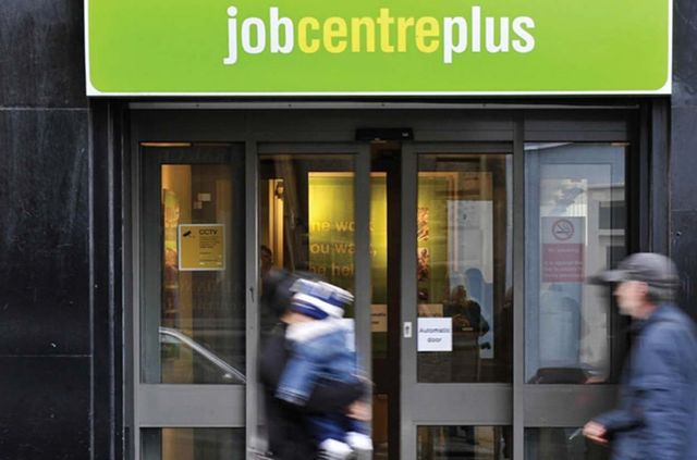 An image of people walking past a job centre plus